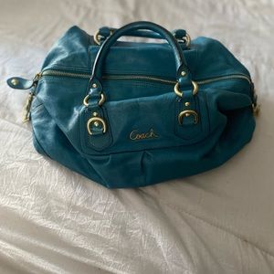 Dark teal leather coach purse.